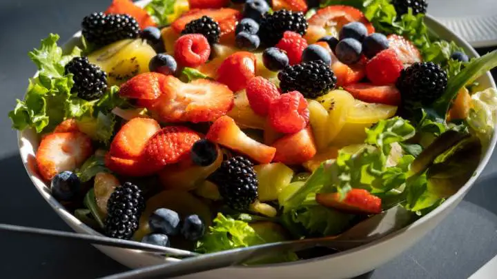 bowl of vegetable salad with berries - millenora